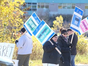 Striking faculty at College Boreal picket at the main entrance of the college in Sudbury, Ont. on Monday October 16, 2017. The Ontario Public Service Employees Union said in release late Sunday that 12,000 faculty members province-wide were on the picket line Monday morning after talks between the union and the College Employer Council failed to produce a tentative collective agreement. Gino Donato/Sudbury Star/Postmedia Network