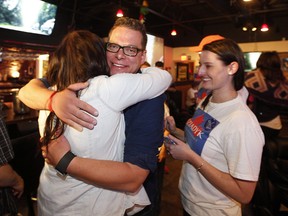 Jon Dziadyk gets a hug after finding out he won in Ward 3. (Greg Southam)