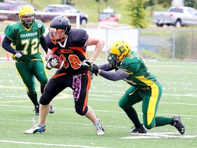 Anthony Moyse-Dombek tries to haul down Mason Bond of the Lasalle Lancers during senior boys football action Confederation Chargersin Sudbury, Ont. on Friday, October 13, 2017. Confederation is one of four teams opening SDSSAA playoffs on Tuesday. Gino Donato/Sudbury Star/Postmedia Network