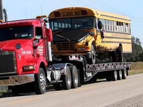 Chatham-Kent police report a 78-year-old Wallaceburg, Ont. woman suffered serious, but non-life threatening injuries after her vehicle collided with this school bus, being shown towed from the scene at Croton Line and Dawn Mills Road, east of Dresden, Ont. on Tuesday October 17, 2017. Police said some of the passengers reported minor injuries as result of the collision, but no medical assistance was required. The collision remains under investigation. (Ellwood Shreve/Chatham Daily News)