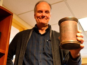 Mike Baker, curator at the Elgin County Museum, holds a bona fide quart-measuring cup from old Elgin County. It will be one of numerous items on display at the new Elgin County Heritage Centre slated to open in early 2018. (Louis Pin/Times-Journal)
