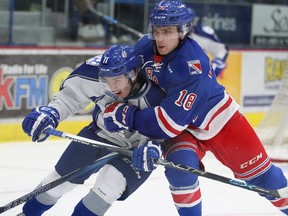 Sudbury Wolves Alan Lyszczarczyk is ties up by Kitchener Rangers Doug Blaisdell during OHL action from the Sudbury Community Arena in Sudbury, Ont. on Friday October 2, 2015. Gino Donato/Sudbury Star/Postmedia Network