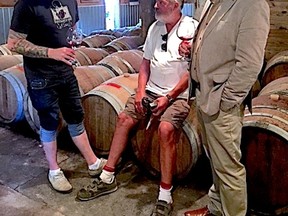 Supplied Photo
Lubomyr Luciuk, right, and winemaker James Lahti, centre, take part in barrel tasting of Pinot Noir wines at Long Dog Winery in Prince Edward County in September 2016.
