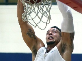 A pumped-up Joel Friesen throws down a dunk during a London Lightning practice at the Central Y on Tuesday. (MIKE HENSEN, The London Free Press)