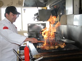 FILE PHOTO
Moe Zubair, a Red Seal chef at The Butter Chicken Co. in Fairview, prepares a meal at the restaurant.