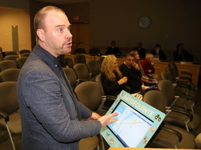 Jason Miller/The Intelligencer
Dug Stevenson unveils one of the new kiosks being used by the Bay of Quinte Regional Marketing Board at this week’s Quinte West council meeting.