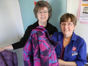 Tim Miller/The Intelligencer
Abby Mills, director of community and family services for the Salvation Army (left) and Marlene Johnston, family service associate, show off some of the coats donated to the Coats For Folks program on Wednesday at the organization’s Pinnacle Street location. The initiative is looking for donations of gently-used winter coats and jackets to be given out to those in need.