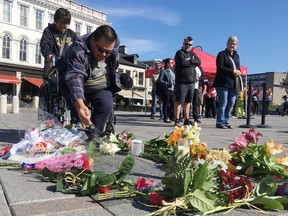 Elliot Ferguson/The Whig-Standard
William Nakogee from the Kashechewan First Nation sprinkles tobacco in Springer Market Square to honour The Tragically Hip lead signer Gord Downie on Wednesday.