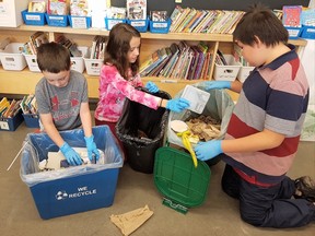 Reece Keyes, left, Paige Dewit and Demitri Nahwegahbo prepare for the waste audit at Walden Public School during Waste Reduction Week. Supplied photo