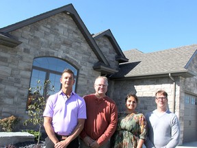 Builders Frank Darco Jr., left, and Scott Henderson, Tarion VP Siloni Waraich, and Alan Shaw, director of planning, building and bylaw enforcement with the City of Sarnia, stand outside a new build on Doral Close. Sarnia has seen positive results, Shaw said, since joining a Tarion pilot two years ago to weed out illegal builders. (Tyler Kula/Sarnia Observer)