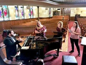 Little London Community Opera music director Ethan Lacey (left), singer Meagan Audia-Bryant, singer Hillary Tufford, and singer Lauren Bryant-Monk rehearse for their debut performance. (Photo submitted)