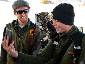 B. Davidson student Bryant Thorpe, right, takes a selfie with Jack the great horned owl and Matthew Morgan, a wildlife educator with the Canadian Raptor Conservatory. Morgan ran one of four exhibits along Port Stanley yesterday, a chance for students to learn about conservation at the Lake Erie Student Conference. (Louis Pin // Times-Journal)