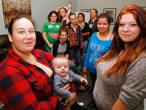 Luke Hendry/The Intelligencer 
Clients of Abigail's Learning Centre, a United Way member agency in Belleville, gather for a photo at the centre Thursday. In the foreground are Amber E., holding Ayden, and Kaylie Fulford. Background, left to right: Ayden's mother, Cassie, Stephanie Winfrey with daughter Ainslee, Victorya (seated), Amber H., Joelle and Savannah.