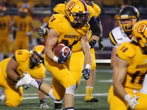 Queen's Golden Gaels running back Jake Puskas runs for yardage against the Waterloo Warriors during OUA Sport football action at Richardson Stadium in Kingston earlier this month. (Ian MacAlpine/The Whig-Standard)