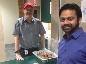 Integration manager Mike Elliot serves up burgers to Farrukh Sajid, Electrical Lead AST2 Project, both of NOVA Chemicals, as part of the company’s fundraising barbecue this week. NOVA Chemicals matches all employee and retiree United Way donations until the end of November. Currently, the United Way of Sarnia-Lambton has reached 53 per cent of its $2-million goal. (Handout)