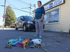 Elliot Ferguson/The Whig-Standard
Heidi Wassef, owner of David’s Convenience on Thomas Street, stands next to some of the garbage that has littered the ground outside her store after a city garbage can was removed. The city says the can is to be replaced in the next few weeks.