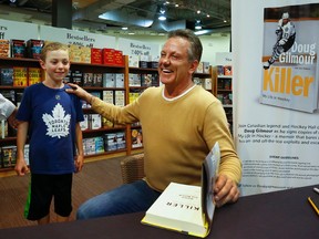 Canadian legend and Hockey Hall of Famer, Doug Gilmour shares a laugh with Colin Casey, 8, as he signs copies of Killer: My Life In Hockey -  a memoir that bares all about his on- and off-the-ice exploits and escapades on Thursday October 19 in Peterborough, Ont. Gilmour will sign books at the Wal-Mart in Kingston from 1-3 p.m., Saturday, Oct. 21. 
CLIFFORD SKARSTEDT/POSTMEDIA NETWORK