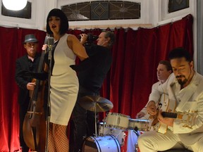 Photo courtesy of Gord Hunter
Director Max Montalvo gets a closeup of bassist Gord Sinclair as Emily Fennell, Rob Radford, and Rob Baker play during the shoot at the Grad Club Sunday night for the video of the song "Land of Greed," from Miss Emily's new record, In Between.