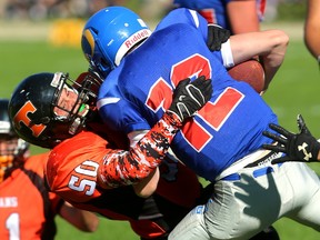 Clarke Road's Jose Rivera-Hernandez tackles Oakridge quarterback Jake Montgomery during their game Friday at Oakridge. Clarke Road was up 7-0 after a blocked punt was taken in for a touchdown with less than a minute gone in their game. And from then on it continued to a 28-0 first quarter before Clarke Road started to throttle back and finished the half at 42-6. The final was 55-6, although posted as 41-6 due to the 35 pt rule. (MIKE HENSEN, The London Free Press)