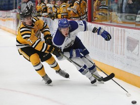 Michael Pezzetta, right, of the Sudbury Wolves, and Nick Grima, of the Sarnia Sting, fight for possession of the puck during OHL action at the Sudbury Community Arena in Sudbury, Ont. on Friday October 20, 2017. John Lappa/Sudbury Star/Postmedia Network