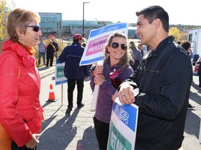 Nickel Belt MPP France Gelinas, left, speaks with Kristy Beadman and Camille Lemieux at a rally for striking faculty at College Boreal and Cambrian College at the picket line at College Boreal in Sudbury, Ont. on Friday October 20, 2017. John Lappa/Sudbury Star/Postmedia Network
