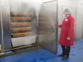 Pawel Zwerello, a food safety co-ordinator at Sikorski Sausages, opens the door of a sausage smoker at the company’s London plant. Sikorski is part of Ontario’s booming agri-food sector, one a new report suggests faces huge recruiting and hiring challenges to keep up with its growth. (DEREK RUTTAN, The London Free Press)