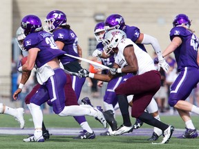 Ottawa Gee Gee Luke French reels in Western Mustang Michael Sananes with his shirt at TD Stadium in London, Ont. on Saturday Oct. 21, 2017. The Mustangs won the game 63-10. Derek Ruttan/The London Free Press/Postmedia Network