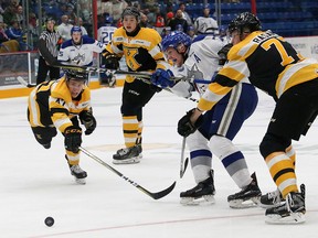 Reagan O'Grady, middle, of the Sudbury Wolves, is surrounded as he fires a shot on net against the Kingston Frontenacs during OHL action at the Sudbury Community Arena in Sudbury, Ont. on Saturday October 21, 2017. John Lappa/Sudbury Star/Postmedia Network