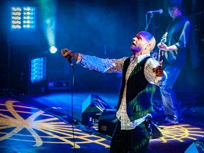 The late Gord Downie is shown on stage with The Tragically Hip in a photograph by Richard Beland, who grew up in Bright's Grove and photographed the band approximately 150 times since the early 1990s. (Handout)