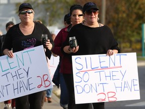 Brandy Ringelmann (right) leads the way during a candlelight vigil march for survivors of sexual assault on Sunday October 22, 2017 in Trenton, Ont. The march was part of the inaugural Healing Circle and Candlelight Vigil March hosted by the G. May Project. Tim Miller/Belleville Intelligencer/Postmedia Network