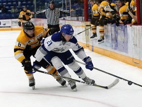 Greater Kingston minor hockey grad Nolan Hutcheson, right, of the Sudbury Wolves attempts to skate around Kingston Frontenacs defenceman Jacob Paquette during OHL action at the Sudbury Community Centre on Saturday night. The Wolves won 3-2. (John Lappa/Postmedia Network)