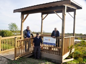 Pete Huitema (left), president of the Mitchell Rotary Club, Dave Brown and Bert Vorstenbosch, Sr., chair of the West Perth Energy & Environment Committee, stand at the new bird viewing stand recently completed at the entrance of the West Perth Wetlands. ANDY BADER/MITCHELL ADVOCATE