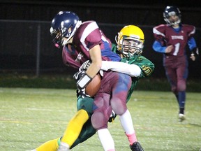 A Centennial defender tackles a St. T's ballcarrier during recent junior football action at MAS 2. Playoffs start Thursday. (Submitted photo)