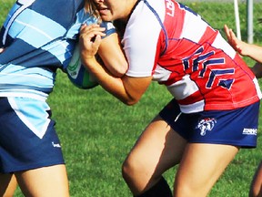 Loyalist women's rugby Sevens standout Rachelle Malette stops an Sheridan Bruins ballcarrier during OCAA regular-season action last weekend in Oakville. She is the Loyalist College Athlete of the Week. (Lancers Athletics photo)
