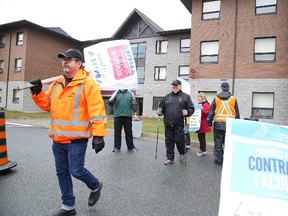 Striking faculty at Cambrian College picket near a college residence in Sudbury, Ont. on Monday October 23, 2017. About 12,000 faculty members province-wide have been on the picket line since last Monday morning after talks between the union and the College Employer Council failed to produce a tentative collective agreement.There are no new talks scheduled.Gino Donato/Sudbury Star/Postmedia Network