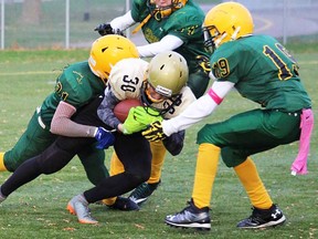 Centennial defenders engulf a Trenton ballcarrier during junior football action Monday night at MAS 2. (Submitted photo)