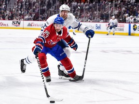 Victor Mete #53 of the Montreal Canadiens skates the puck against Eric Fehr #23 of the Toronto Maple Leafs during the NHL game at the Bell Centre on October 14, 2017 in Montreal, Quebec, Canada. (Photo by Minas Panagiotakis/Getty Images)