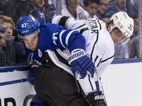 Toronto Maple Leafs centre Leo Komarov gets crunched into the boards on Oct. 23, 2017. (Craig Robertson/Postmedia Network)