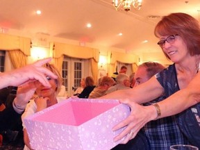 BRUCE BELL/The Intelligencer
Mary Stever, one of the organizers of 100 People Who Care PEC, collects ballots at the Waring House on Monday evening. The Prince Edward Learning Centre was selected as the first recipient of close to $10,000 in donations.