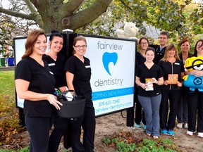 Staff at Fairview Dentistry -- including, from left, Denise Wolsey, Lindsay Bogart, Krystal Venner, Danielle Campbell, Andrea Kapogiannis, Dr. Stan Kravtsov, Brenda Gregory, Karen Carter, and Anne Gilmore -- are excited for Cash for Candy, a new initiative they're using to try and curb after-holiday binge eating. They're offering $1 per pound of candy brought into their office between Nov. 1 and Nov. 22. (Louis Pin/Times-Journal)