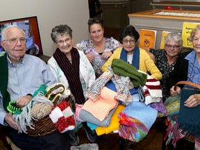 Residents and staff of the Trillium Retirement And Care Community show off some of the 100 or so scarves they knitted as part of their scarf bombing projects on Tuesday. Left to right, Gordon Priest, 92, Vera Bennett, 94, staff member Mallory Paige, Margaret Fotschuk, 84, staff member Lynda Rossetti and Clara Niemi, 92. (Ian MacAlpine/The Whig-Standard)