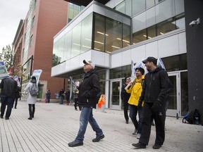 Striking faculty members picket the downtown campus of Fanshawe College in London Tuesday. (DEREK RUTTAN, The London Free Press)