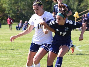 Catherine Rocca, left, of Laurentian Voyageurs, battles for the ball with Delaney Borsato, of Nipissing Lakers, during soccer action at Laurentian University in Sudbury, Ont. on Saturday September 9, 2017. John Lappa/Sudbury Star/Postmedia Network