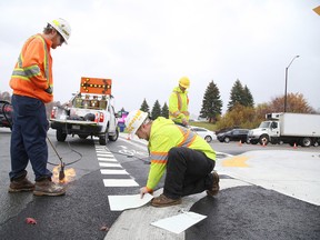 Gino Donato/Sudbury Star/Postmedia Network

A crew from McGuinness Coatings was putting the final touches affixing thermoplastic markings at the corner of Ramsey Lake Road and Paris Street at Sudbury's first crossride on Tuesday. A formal introduction of the crossride will be held Wednesday. A crossride is a dedicated space at an intersection, identified by unique pavement markings, for cyclists to legally ride their bicycles through an intersection without dismounting.