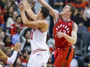 Jakob Poeltl of the Toronto Raptors battles for a rebound with Paul Zipser of the Chicago Bulls in an NBA game last week in Toronto. Poeltl is establishing a reputation for hard work and solid defence. (Ernest Doroszuk/Postmedia News )