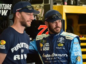 Martin Truex Jr, right, talks with crew chief Cole Pearn of Mt. Brydges during practice for a race at Charlotte Motor Speedway earlier this month in Charlotte, N.C. The team has been dogged by personal tragedy this season, including the death, just days ago, of crew member Jim Watson. (Jared C. Tilton/Getty Images )