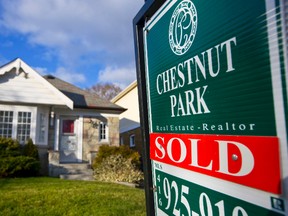 A "Sold" sign stands outside an existing home for sale in Toronto, Ontario, Canada, on Monday, Nov. 30, 2009. (Norm Betts/Bloomberg)