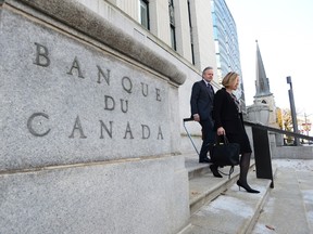 Governor of the Bank of Canada Stephen Poloz and Carolyn Wilkins, Senior Deputy Governor, make their way to the National Press Gallery in Ottawa on Wednesday, October 25, 2017. THE CANADIAN PRESS/Sean Kilpatrick