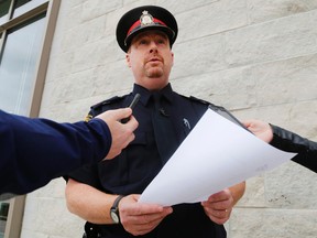 Luke Hendry/The Intelligencer
Belleville Police Insp. Chris Barry reads from a prepared statement outside the Quinte courthouse in Belleville Wednesday. Though all criminal charges against the late Dr. Garry Solomon have been withdrawn, Barry said police are still investigating and trying to identify patients shown in videos recorded at Solomon's office.