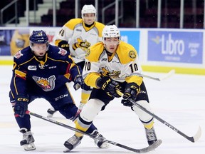 Sarnia Sting's Anthony Salinitri, right, protects the puck from Barrie Colts' Alexey Lipanov in the first period at Progressive Auto Sales Arena in Sarnia, Ont., on Friday, Oct. 6, 2017. (MARK MALONE, Postmedia Network)